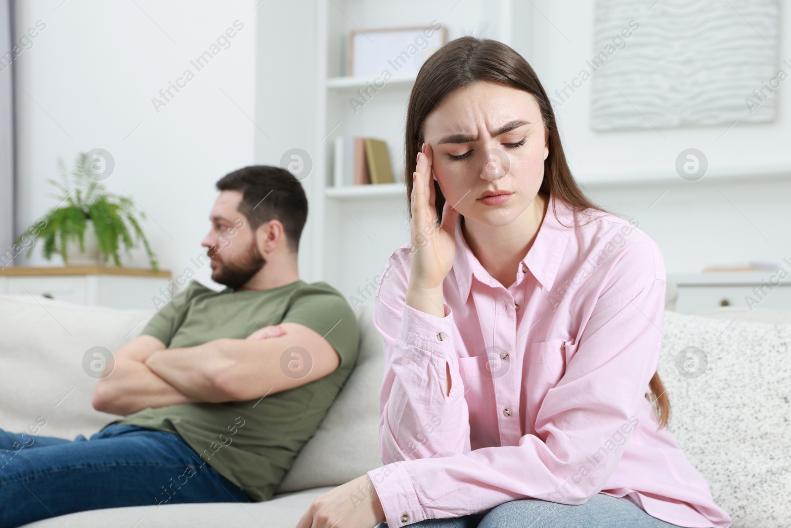 Photo of Resentful couple sitting on couch at home, selective focus