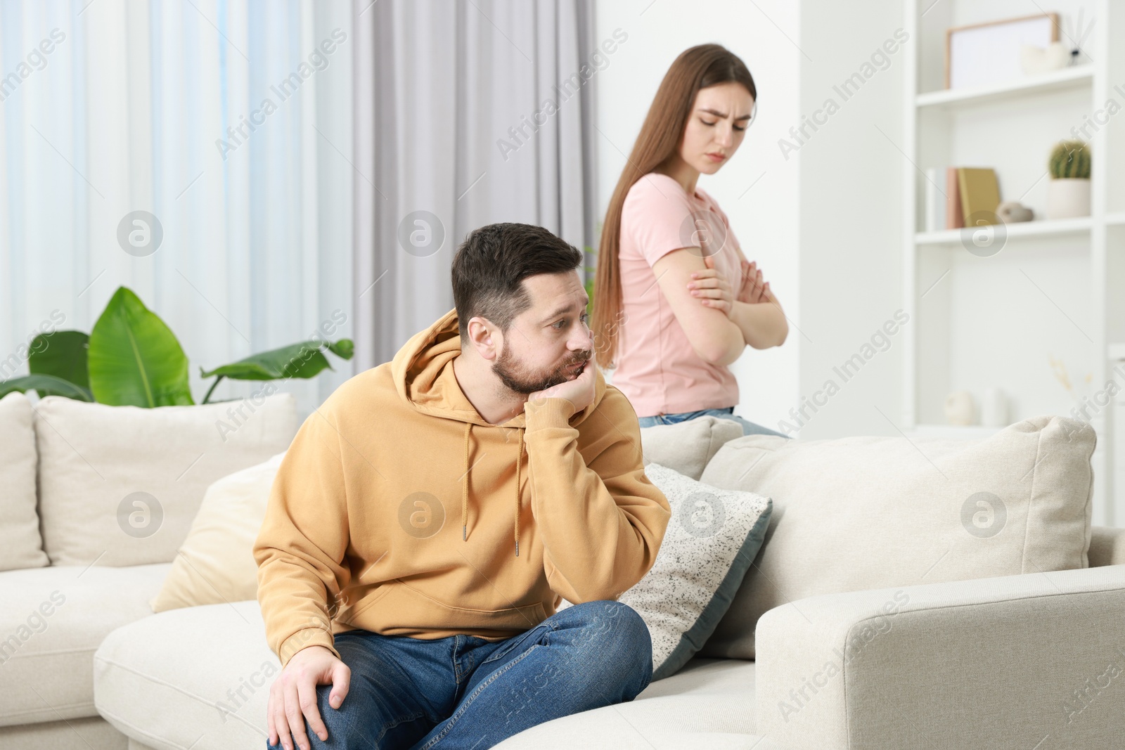 Photo of Resentful couple in living room, selective focus