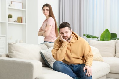 Photo of Resentful couple in living room, selective focus