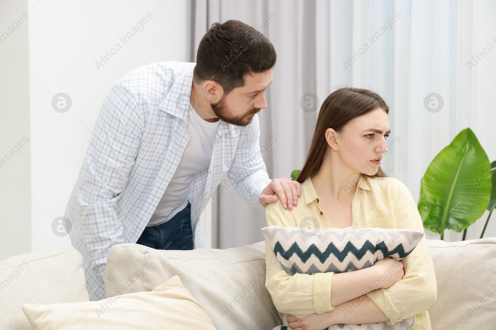 Photo of Man comforting his resentful girlfriend at home