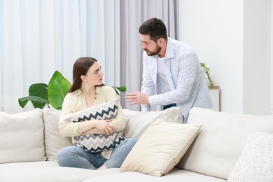 Photo of Man comforting his resentful girlfriend at home