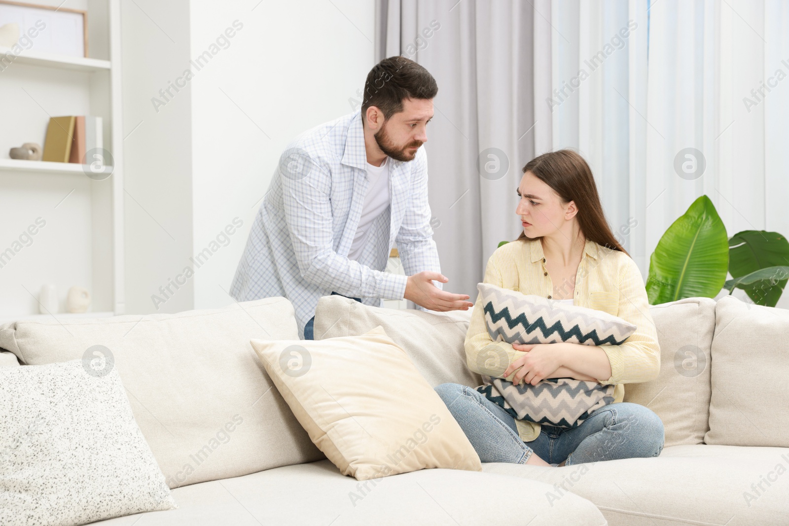 Photo of Man comforting his resentful girlfriend at home