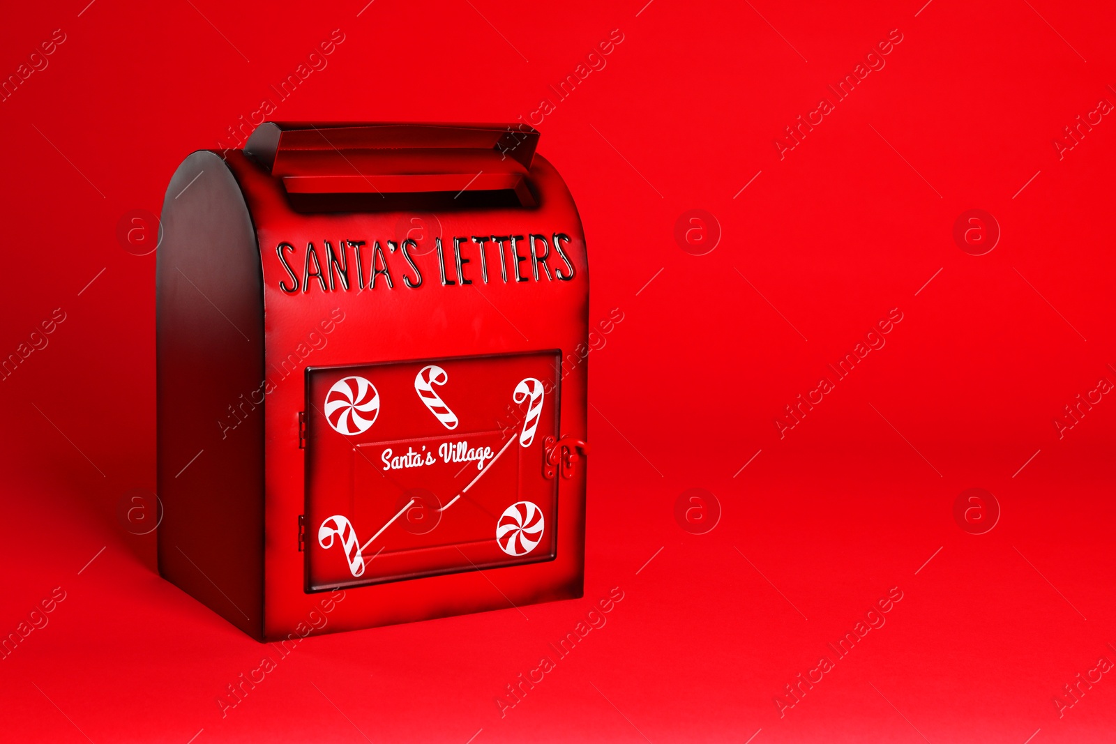 Photo of Santa Claus mailbox on red background, space for text. Christmas tradition