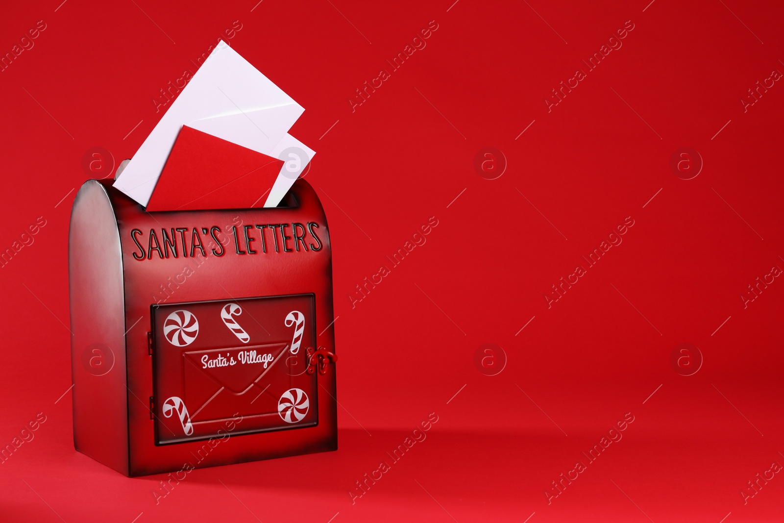 Photo of Santa Claus mailbox with letters on red background, space for text. Christmas tradition