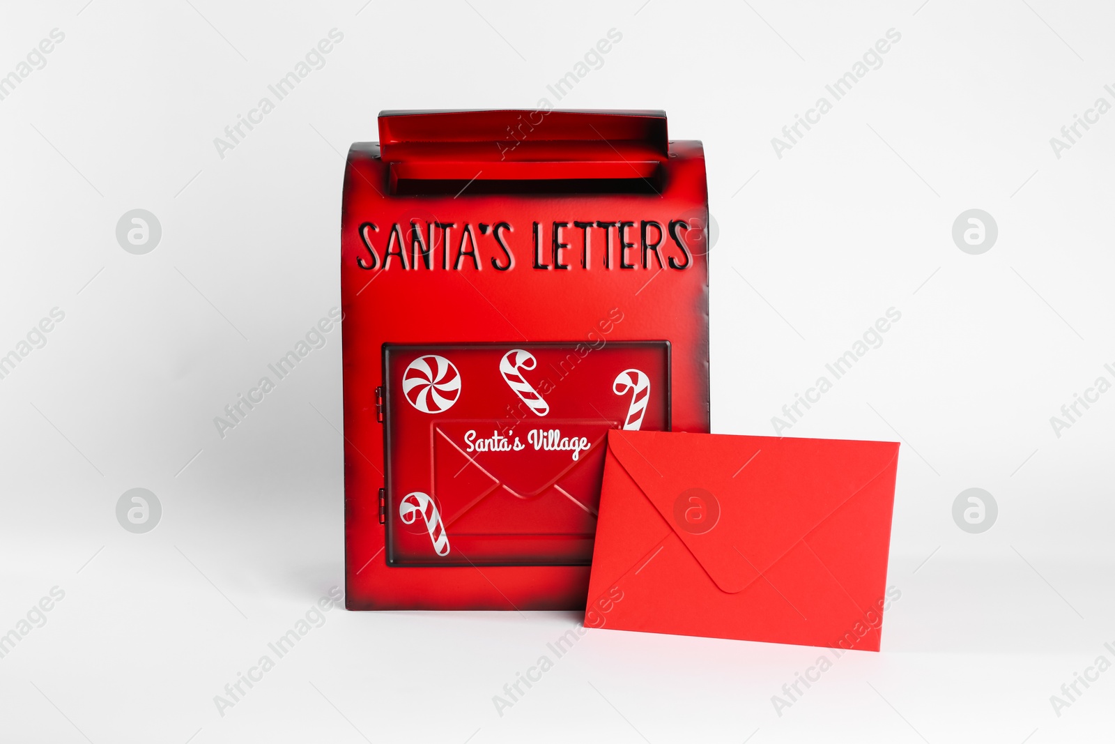 Photo of Santa Claus mail box and letter on white background. Christmas tradition