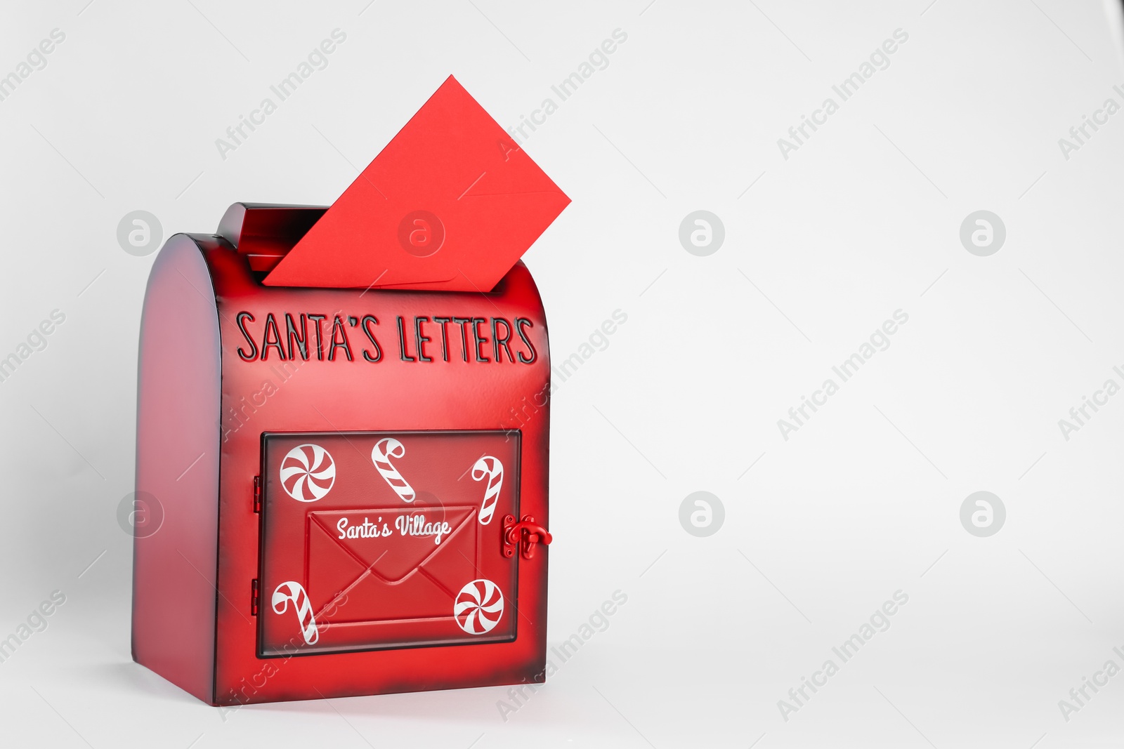 Photo of Santa Claus mail box with letter on white background, space for text. Christmas tradition