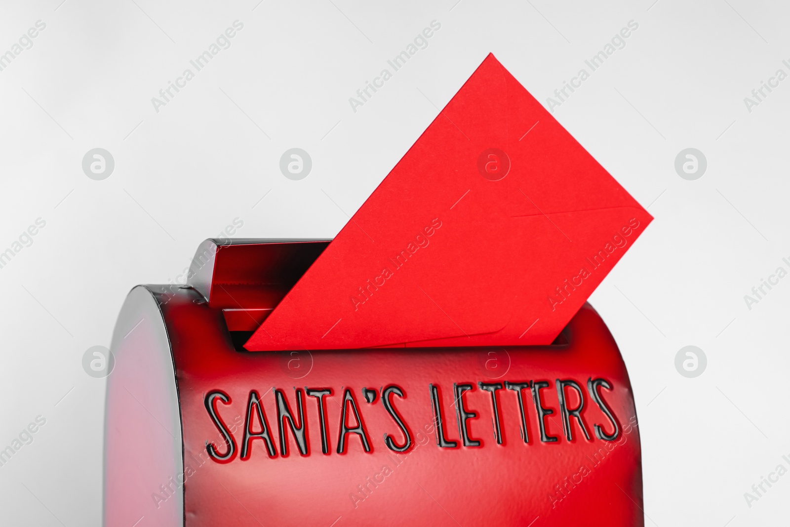 Photo of Santa Claus mail box with letter on white background, closeup. Christmas tradition