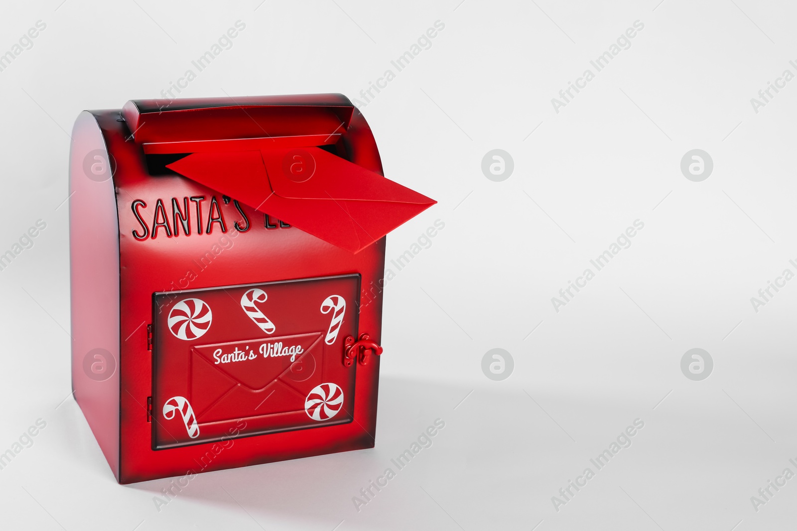 Photo of Santa Claus mail box with letter on white background. Christmas tradition