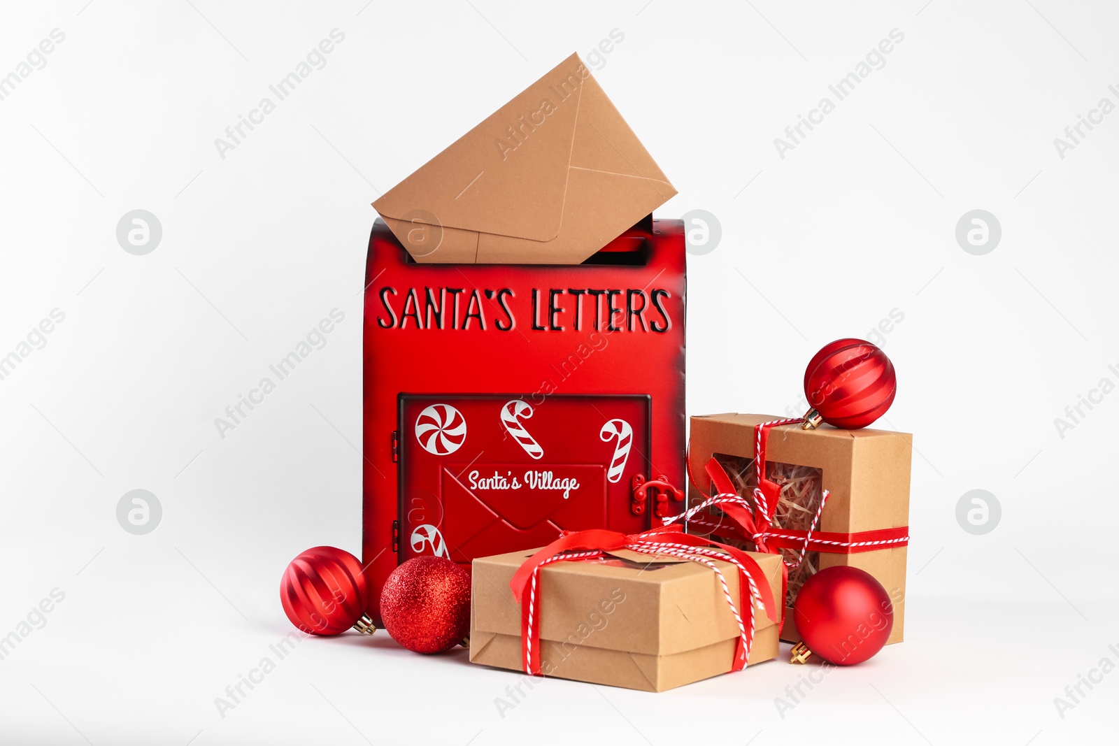 Photo of Santa Claus mail box with letter, gifts and Christmas baubles on white background