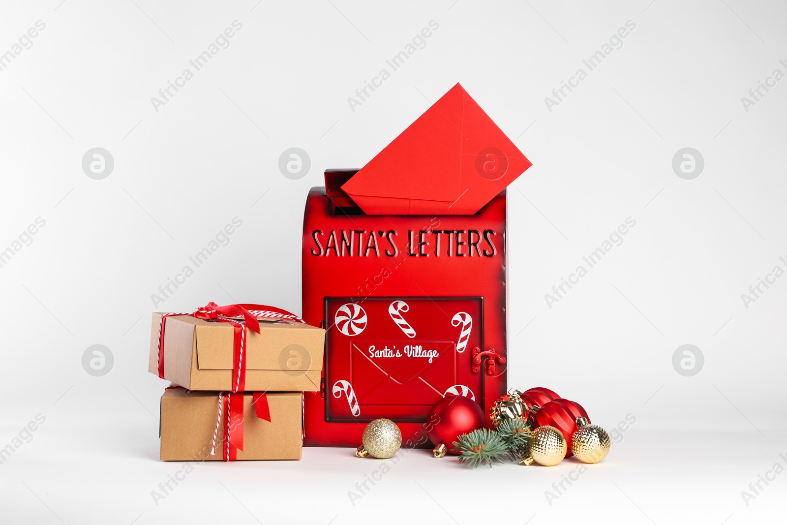 Photo of Santa Claus mail box with letter, gifts and Christmas decor on white background