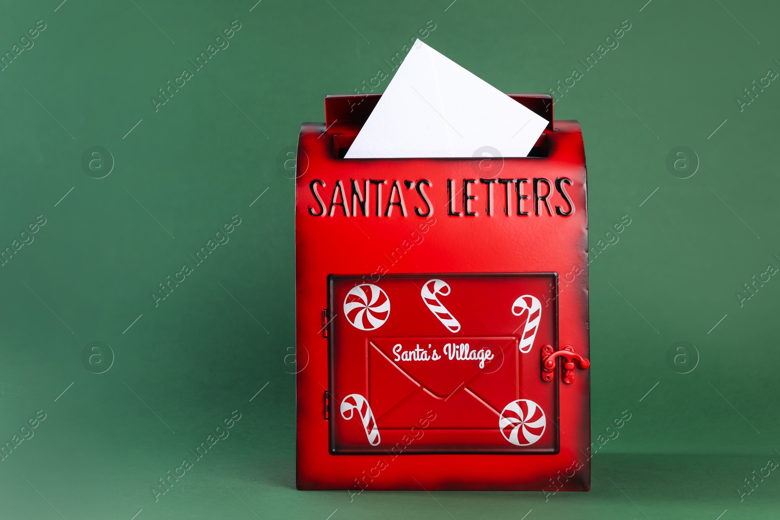 Photo of Santa Claus mail box with letter on dark green background. Christmas tradition