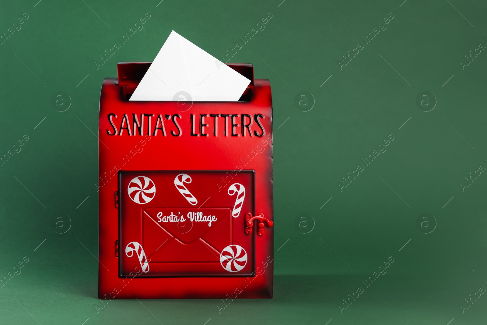 Photo of Santa Claus mail box with letter on dark green background, space for text. Christmas tradition