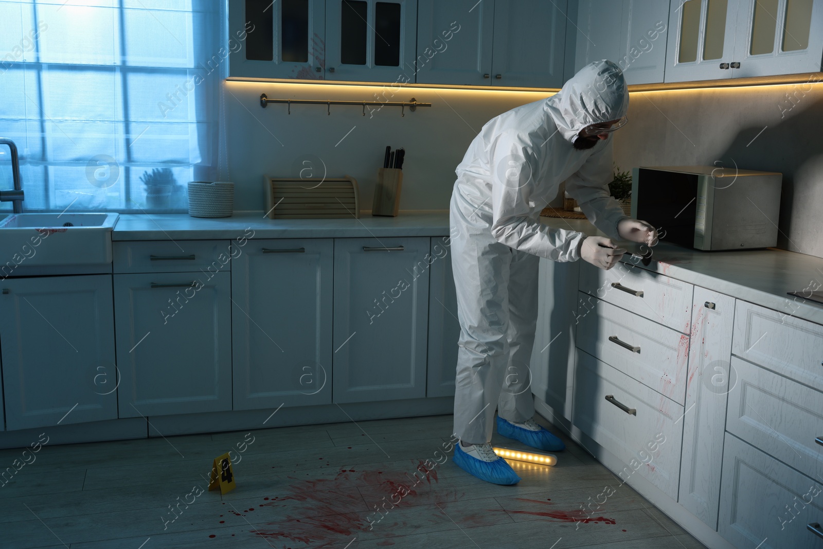 Photo of Forensic expert taking fingerprints from countertop with brush at crime scene indoors, space for text