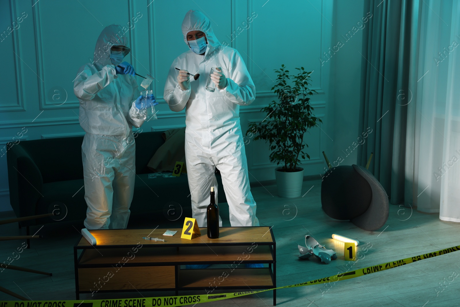 Photo of Forensic experts working at crime scene indoors