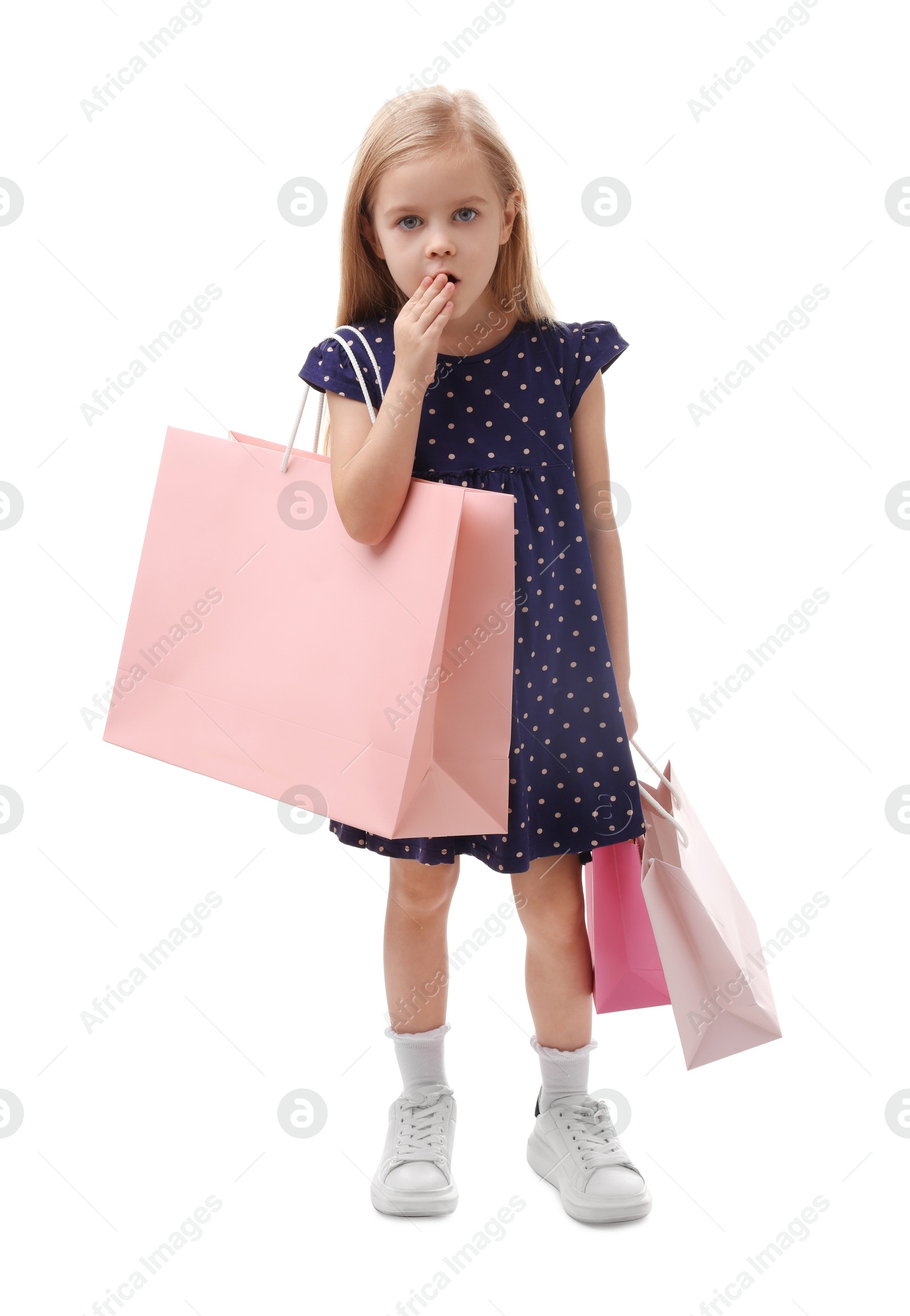 Photo of Little girl with shopping bags on white background