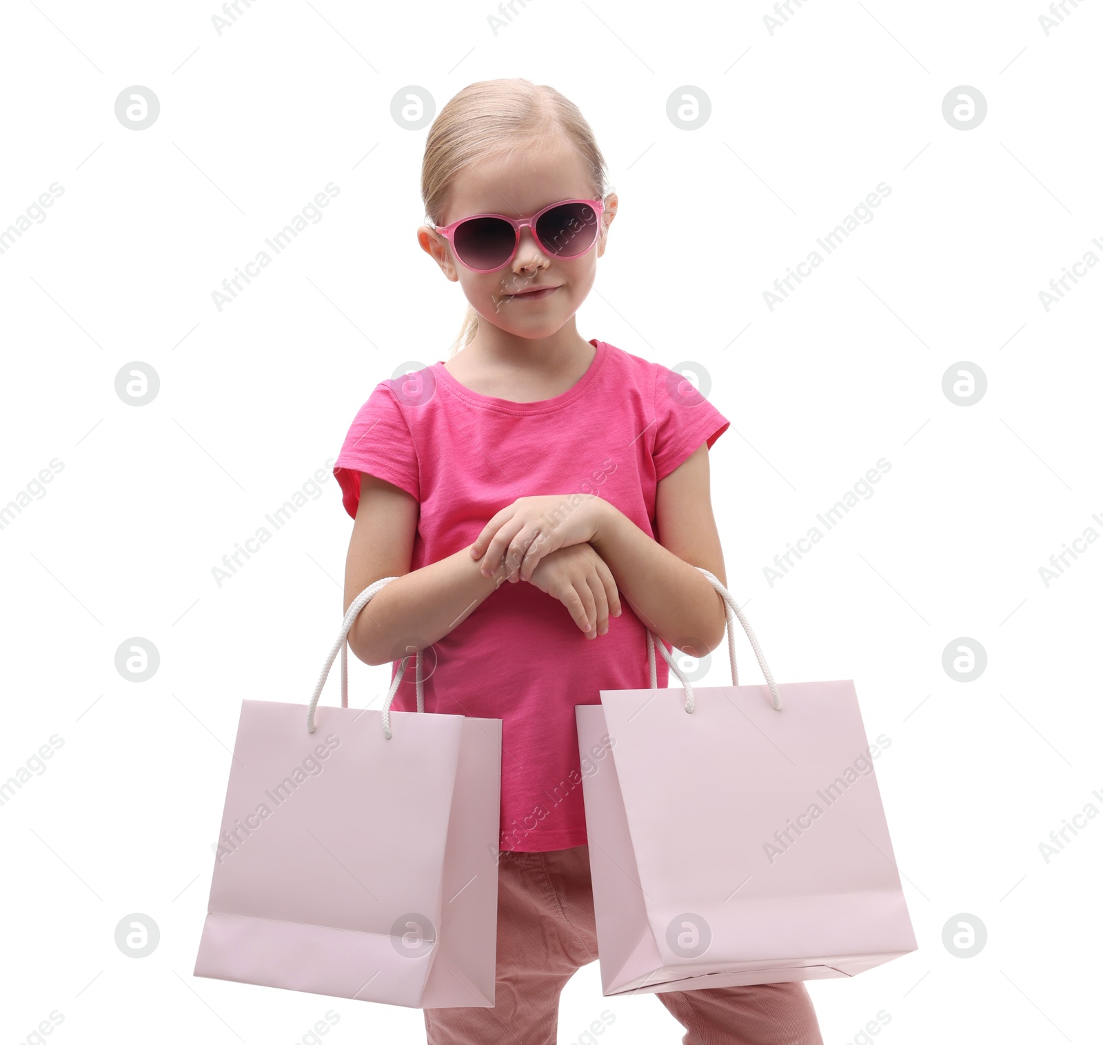 Photo of Little girl with sunglasses and shopping bags on white background