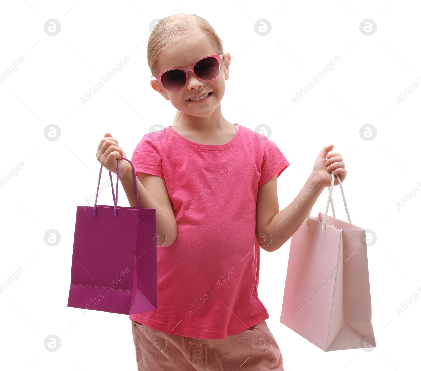 Photo of Little girl with sunglasses and shopping bags on white background