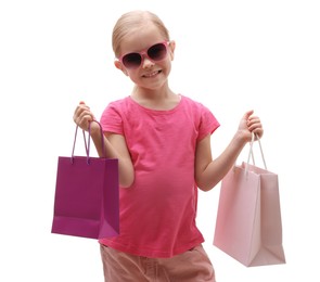 Photo of Little girl with sunglasses and shopping bags on white background