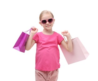 Photo of Little girl with sunglasses and shopping bags on white background