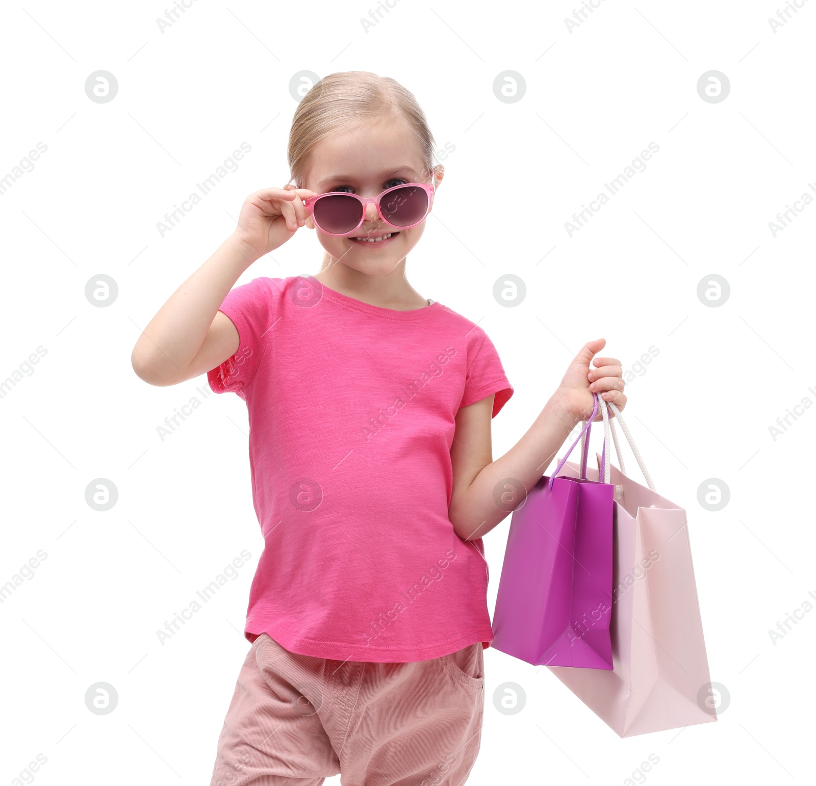 Photo of Little girl with sunglasses and shopping bags on white background