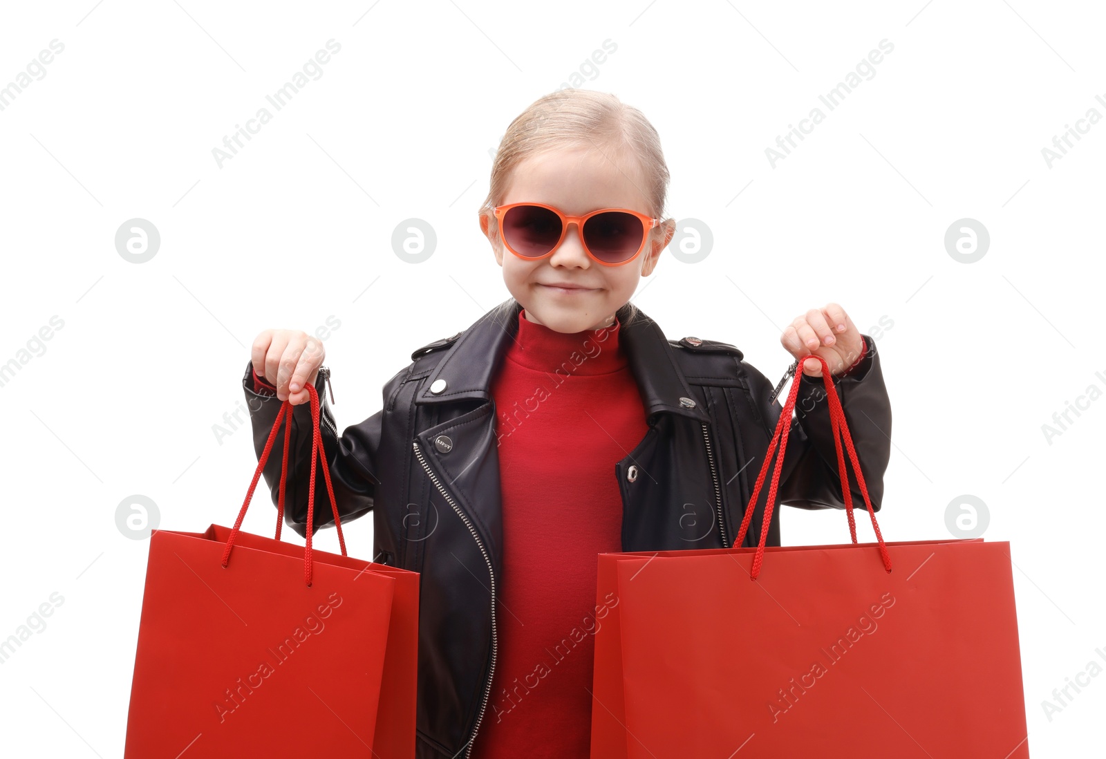 Photo of Little girl with shopping bags on white background