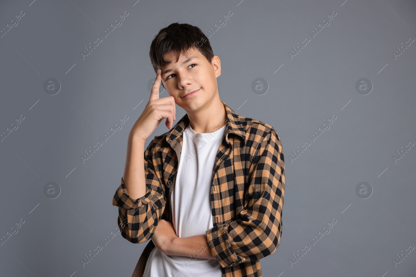 Photo of Portrait of teenage boy on grey background