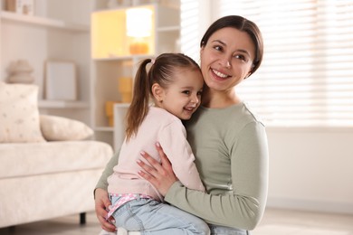 Photo of Family portrait of beautiful mother with little daughter at home