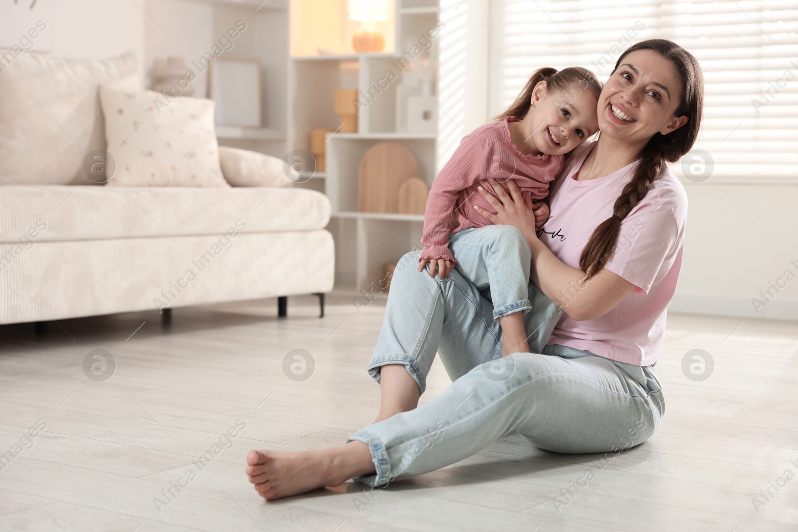 Photo of Happy mother with little daughter spending time together at home. Space for text