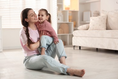 Photo of Happy mother with little daughter spending time together at home. Space for text