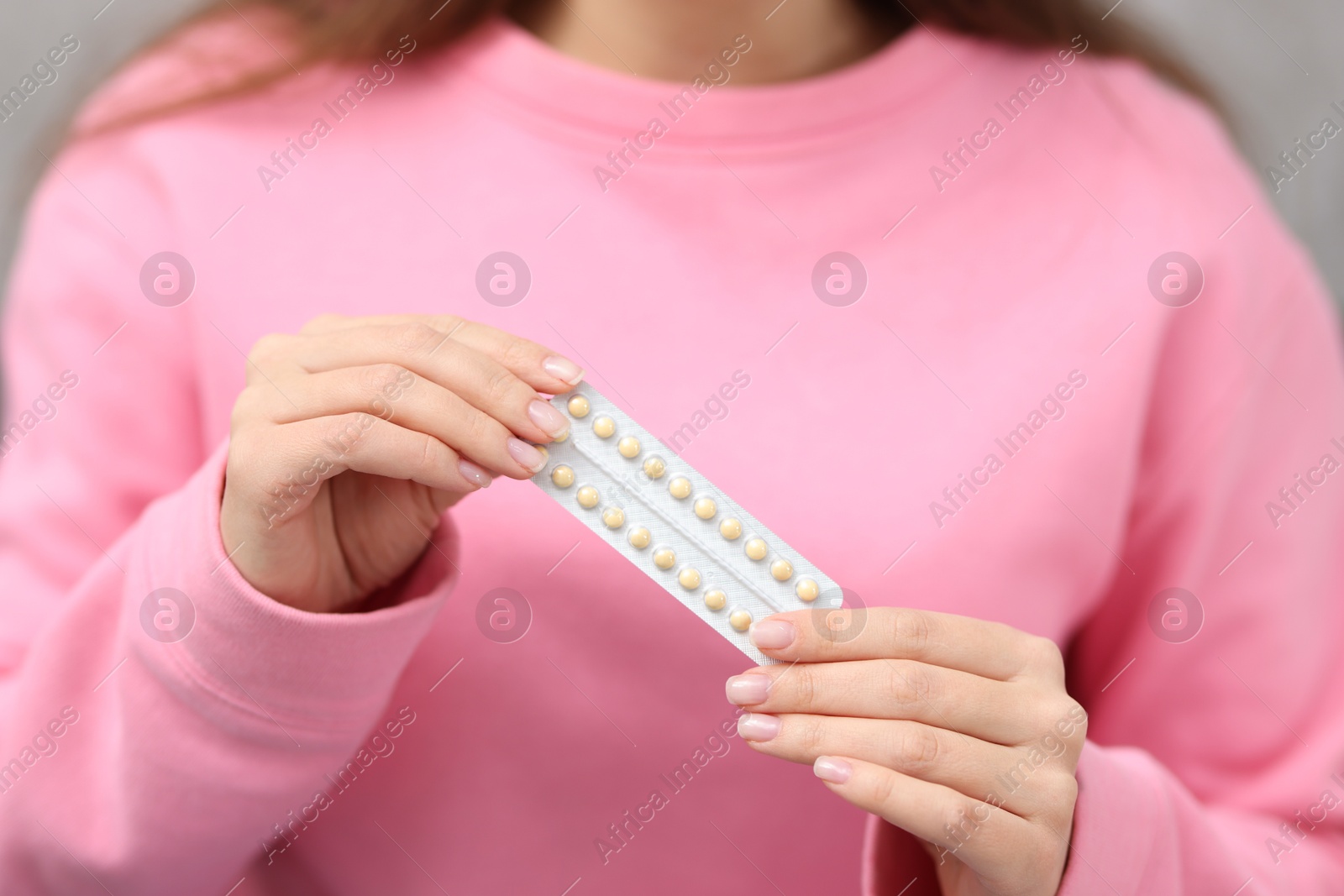 Photo of Woman with blister of contraceptive pills, closeup