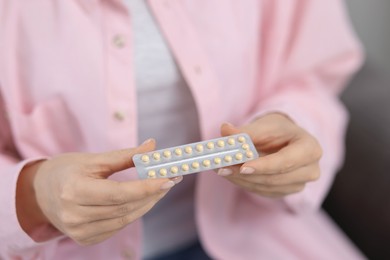 Photo of Woman with blister of contraceptive pills, closeup