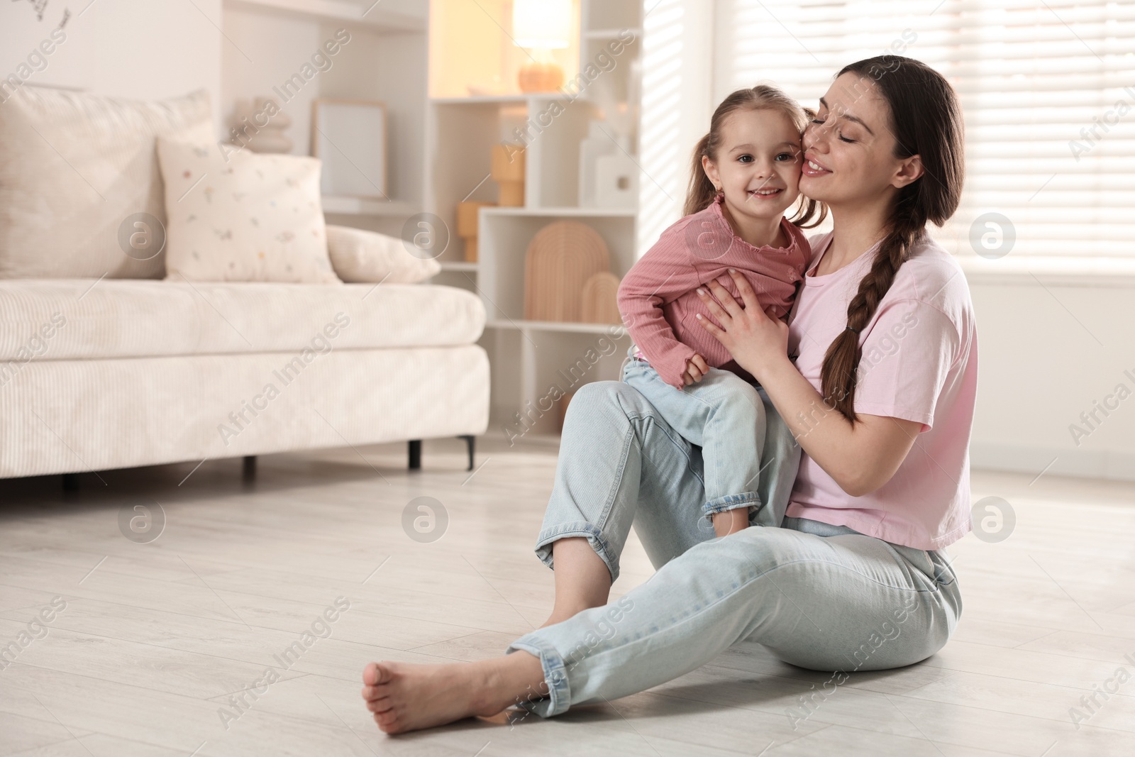 Photo of Happy mother with little daughter spending time together at home. Space for text