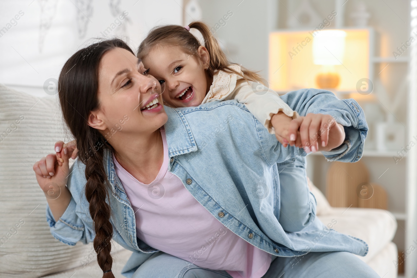 Photo of Portrait of happy mother and her cute daughter at home