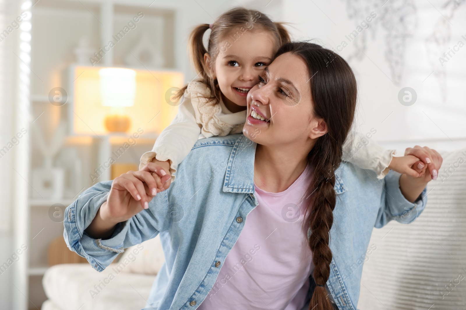 Photo of Portrait of happy mother and her cute daughter at home