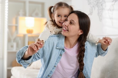 Photo of Portrait of happy mother and her cute daughter at home