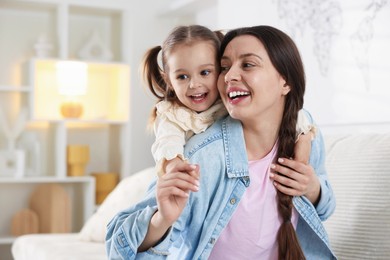 Photo of Portrait of happy mother and her cute daughter at home. Space for text