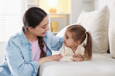 Photo of Happy mother with her cute daughter spending time together at home