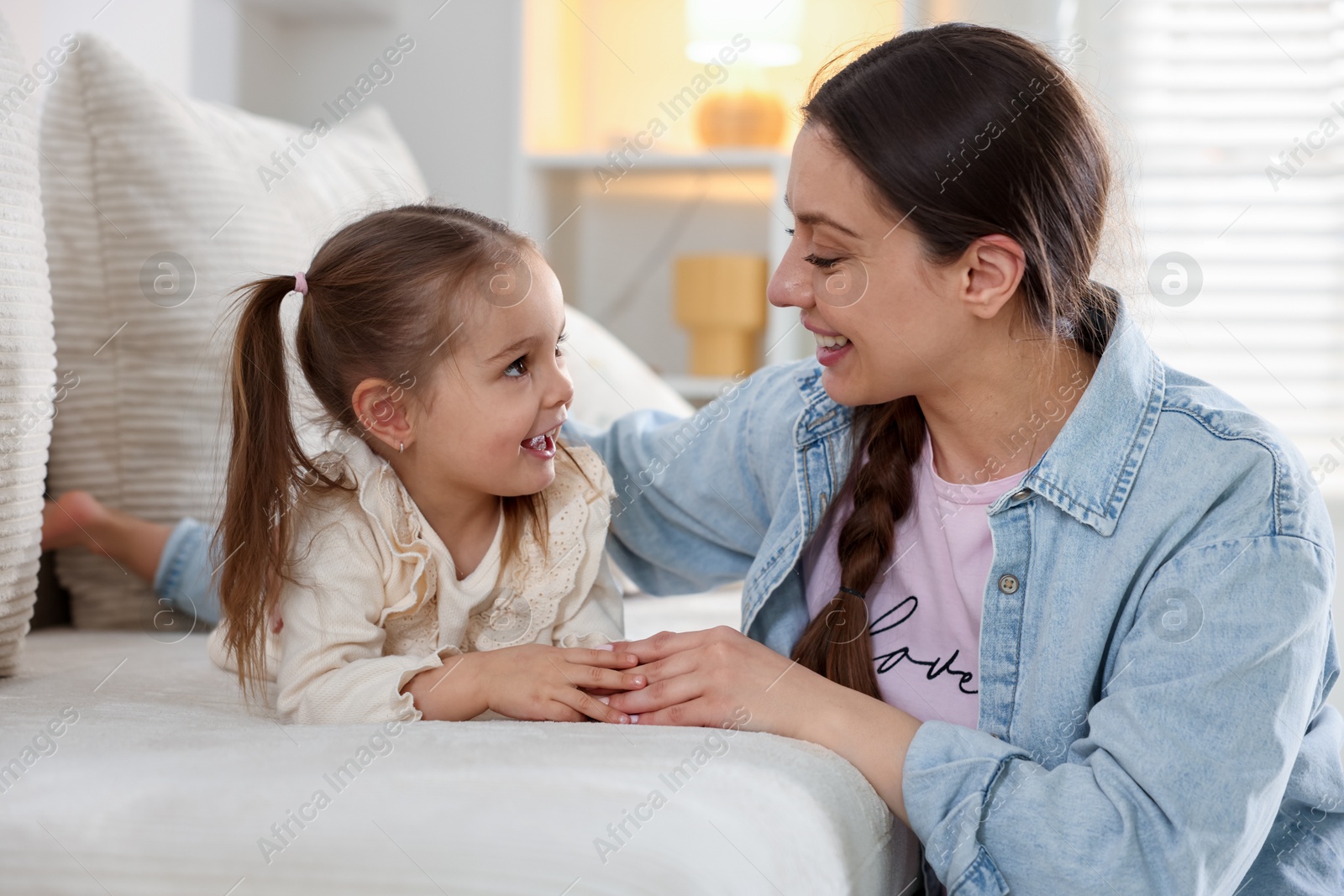 Photo of Happy mother with her cute daughter spending time together at home