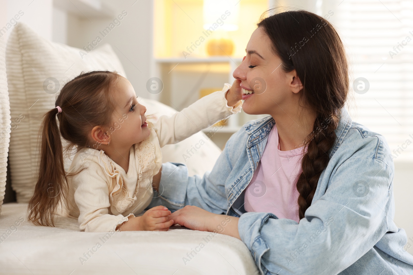 Photo of Happy mother with her cute daughter spending time together at home