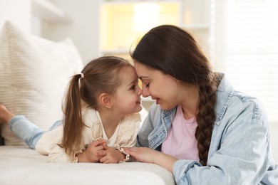 Photo of Happy mother with her cute daughter spending time together at home