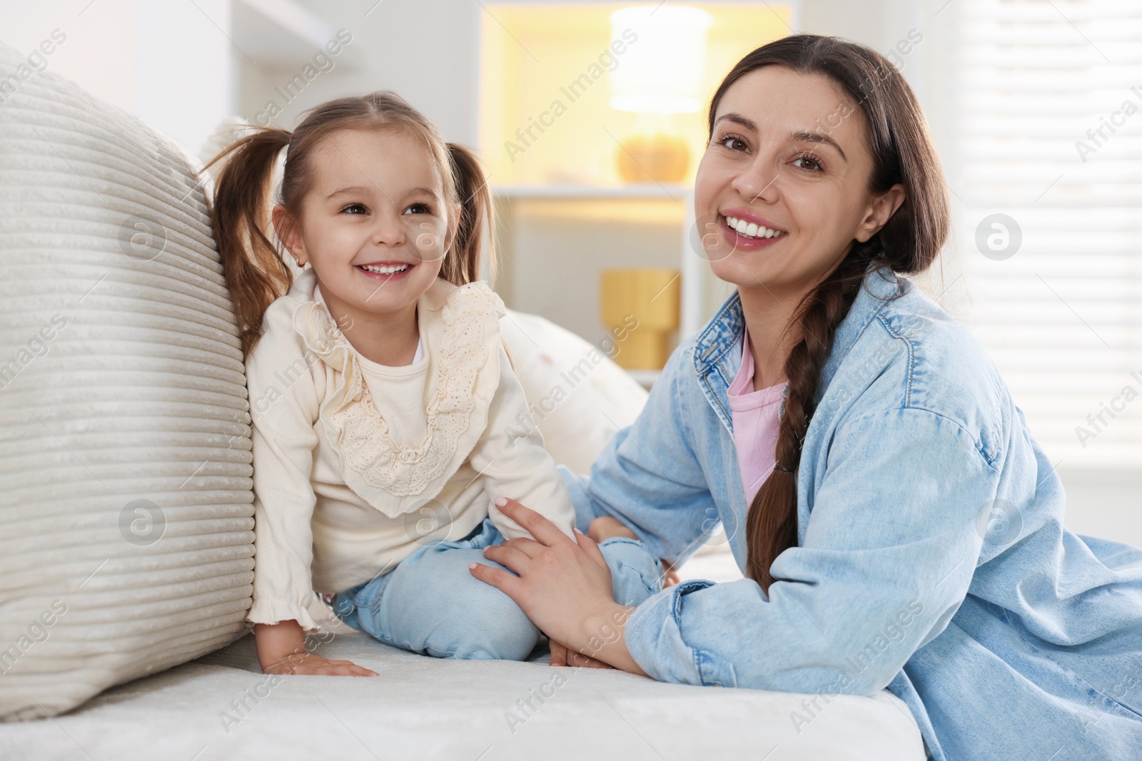 Photo of Happy mother with her cute daughter spending time together at home