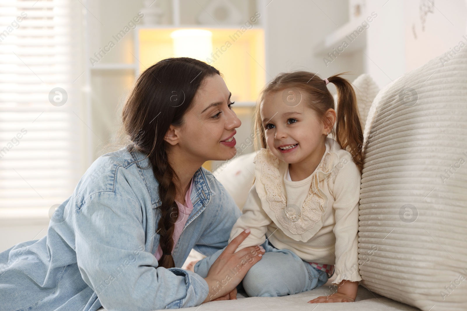 Photo of Happy mother with her cute daughter spending time together at home