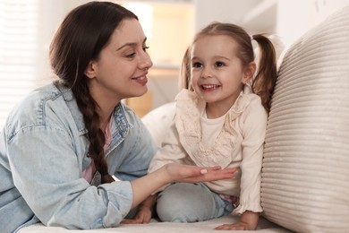 Photo of Happy mother with her cute daughter spending time together at home