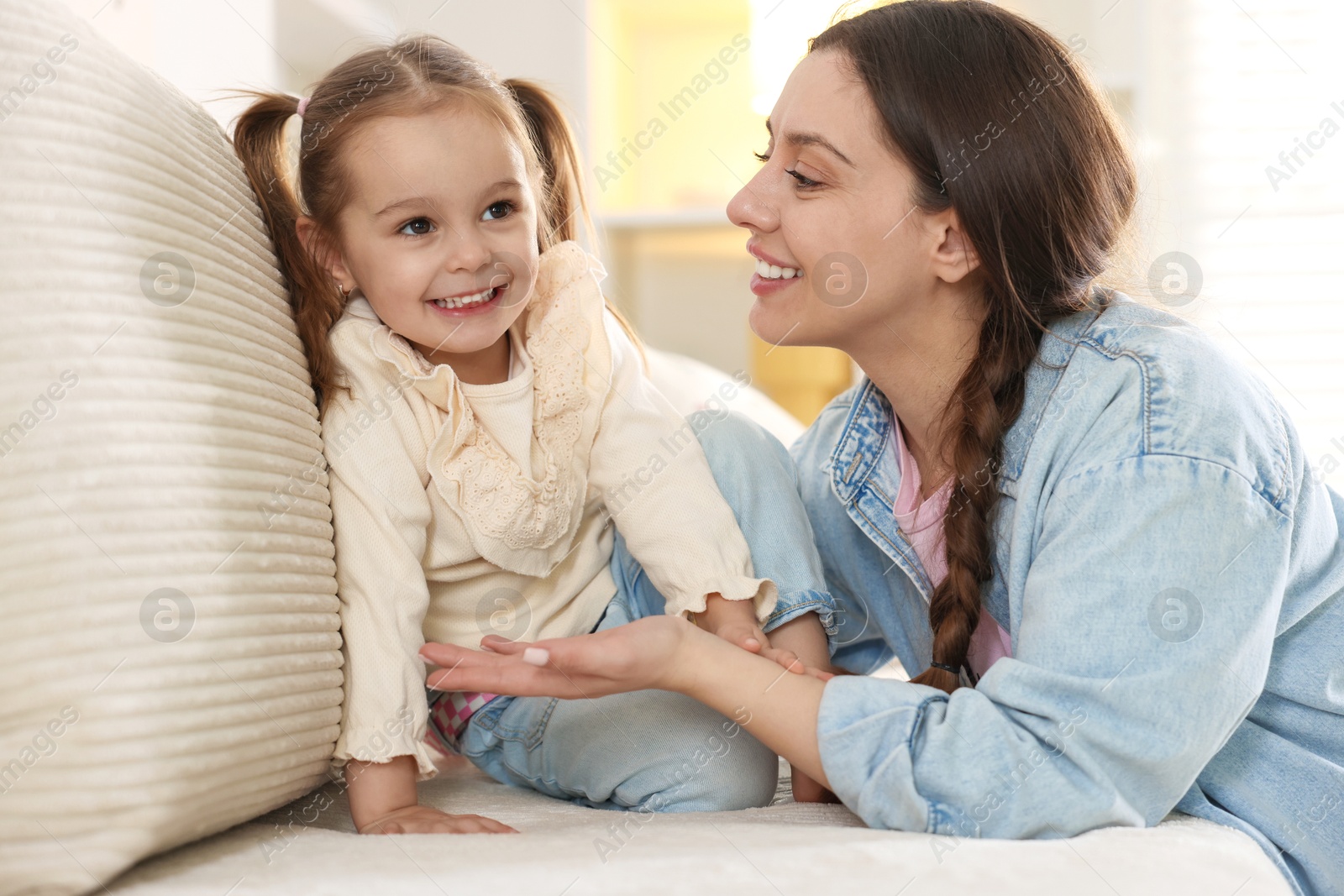 Photo of Happy mother with her cute daughter spending time together at home