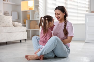 Photo of Happy mother with her little daughter spending time together at home