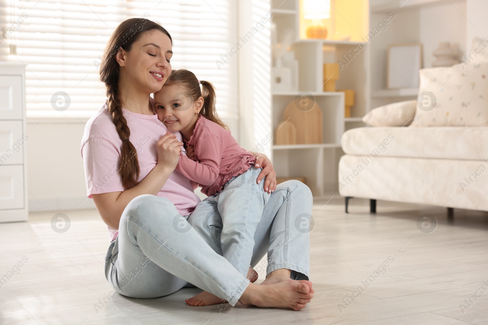 Photo of Happy mother with her little daughter spending time together at home. Space for text