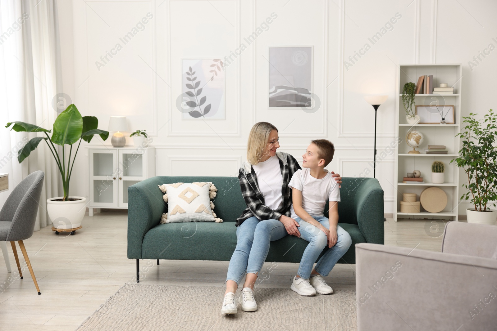 Photo of Mother and son on sofa at home