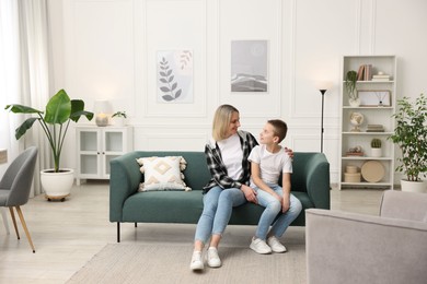 Photo of Mother and son on sofa at home