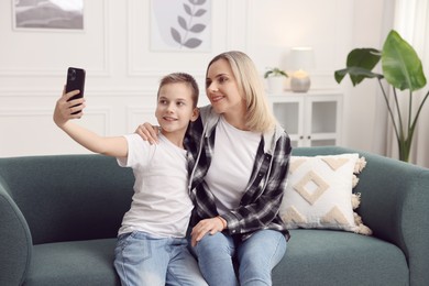 Photo of Mother and son taking selfie at home