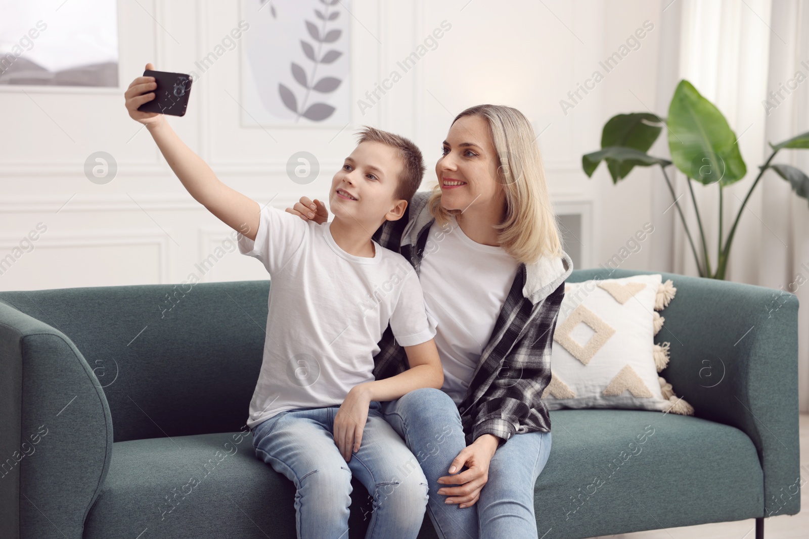 Photo of Mother and son taking selfie at home